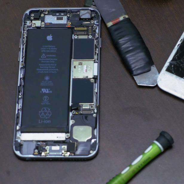 Pieces of an iPhone are seen in a repair store in New York