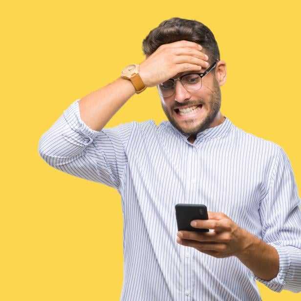 Young handsome man texting using smartphone over isolated background stressed with hand on head, shocked with shame and surprise face, angry and frustrated. Fear and upset for mistake.